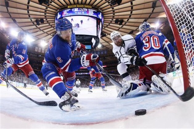 AP10ThingsToSee- New York Rangers defenseman Anton Stralman (6) reaches to save the puck from crossing the goal line as Los Angeles Kings center Jeff Carter (77) tries to score from behind New York Rangers goalie Henrik Lundqvist (30) in the first period during Game 4 of the NHL hockey Stanley Cup finals, Wednesday, June 11, 2014, in New York. (AP Photo/Bruce Bennett, Pool)