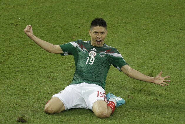 Mexico's Oribe Peralta celebrates after scoring during the group A World Cup soccer match between Mexico and Cameroon in the Arena das Dunas in Natal, Brazil, Friday, June 13, 2014.  (AP Photo/Hassan Ammar)
