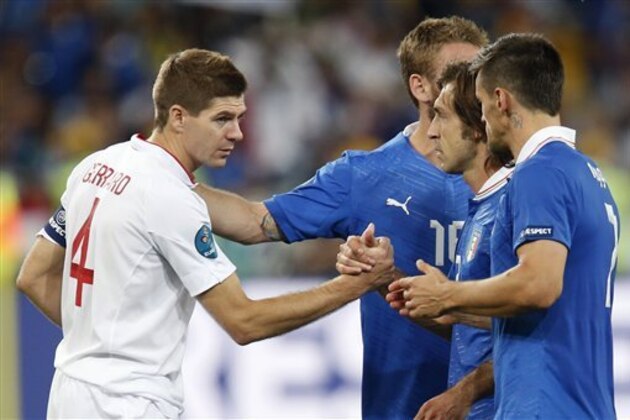 England's Steven Gerrard, left, shakes hands with Italy's Andrea Pirlo, second right, at the end of the Euro 2012 soccer championship quarterfinal match between England and Italy in Kiev, Ukraine, Monday, June 25, 2012. (AP Photo/Matthias Schrader)