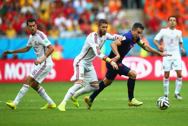SALVADOR, BRAZIL - JUNE 13:  Sergio Ramos of Spain challenges Robin van Persie of the Netherlands during the 2014 FIFA World Cup Brazil Group B match between Spain and Netherlands at Arena Fonte Nova on June 13, 2014 in Salvador, Brazil.  (Photo by Ian Walton/Getty Images)