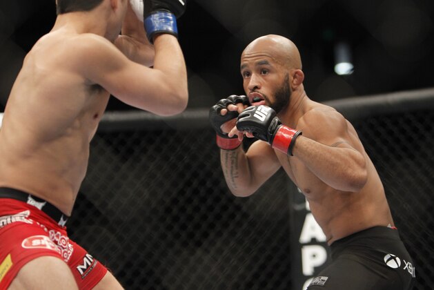 Demetrious Johnson, right, and Joseph Benavidez battle for the UFC Flyweight Mixed Martial Arts title in Sacramento, Calif., on Saturday, Dec. 14, 2013.(AP Photo/Steve Yeater)