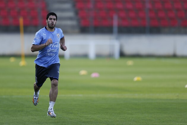 Uruguay's Luis Suarez runs during a training session at Jacare Stadium in Sete Lagoas, Brazil, Tuesday, June 10, 2014. Uruguay continues its preparations for the upcoming 2014 World Cup. (AP Photo/Victor R. Caivano)