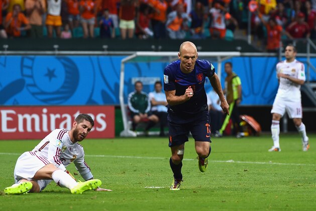 SALVADOR, BRAZIL - JUNE 13: Arjen Robben of the Netherlands reacts after scoring his teams second goal as Sergio Ramos of Spain looks on during the 2014 FIFA World Cup Brazil Group B match between Spain and Netherlands at Arena Fonte Nova on June 13, 2014 in Salvador, Brazil.  (Photo by David Ramos/Getty Images)