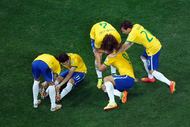 SAO PAULO, BRAZIL - JUNE 12:  Oscar of Brazil lies on the ground in celebration with David Luiz, Dani Alves, Fred and Bernard during the 2014 FIFA World Cup Brazil Group A match between Brazil and Croatia at Arena de Sao Paulo on June 12, 2014 in Sao Paulo, Brazil.  (Photo by Pool/Getty Images)