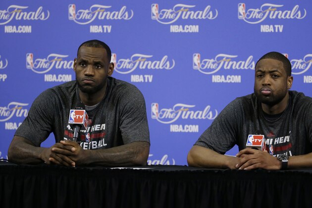 Miami Heat forward LeBron James, left, and Miami Heat guard Dwyane Wade, listen to a questions during a post-game news conference after Game 4 of the NBA basketball finals,  Friday, June 13, 2014, in Miami. The San Antonio Spurs defeated the Miami Heat 107-86. (AP Photo/Wilfredo Lee)