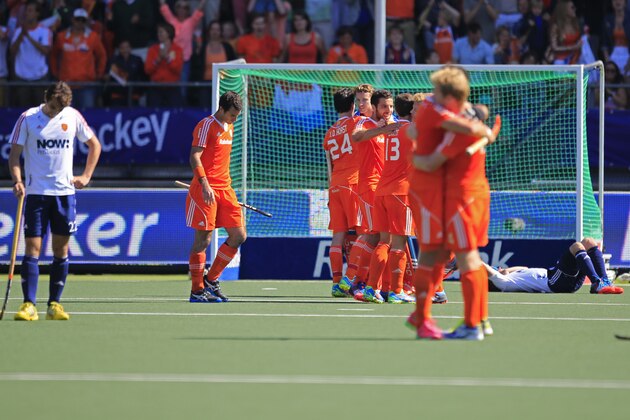 England players, left, and right, look dejected as the Dutch team celebrates winning the Field Hockey World Cup semifinal match men between the Netherlands and England in The Hague, Netherlands, Friday, June 13, 2014. The Netherlands won the match with a 1-0 score and continues to play the final on Sunday. (AP Photo/Peter Dejong) England players, left, and right, look dejected as the Dutch team celebrates winning the Field Hockey World Cup semifinal match men between the Netherlands and England in The Hague, Netherlands, Friday, June 13, 2014. The Netherlands won the match with a 1-0 score and continues to play the final on Sunday. (AP Photo/Peter Dejong)