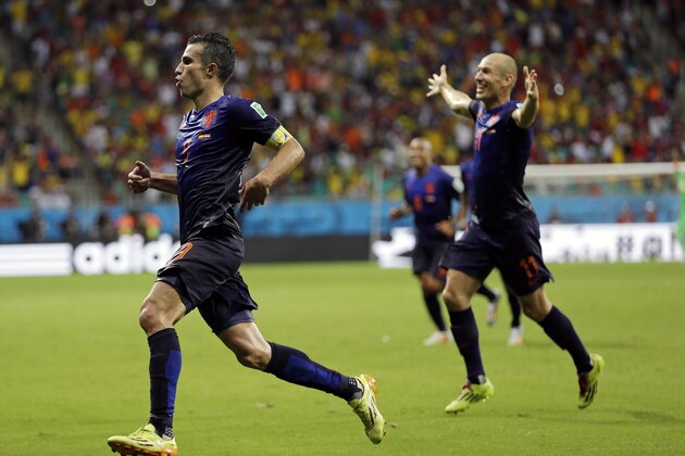 Netherlands' Robin van Persie celebrates with teammate Arjen Robben, right,  after his scoring his side's fourth goal during the second half of the group B World Cup soccer match between Spain and the Netherlands at the Arena Ponte Nova in Salvador, Brazil, Friday, June 13, 2014.  (AP Photo/Natacha Pisarenko)