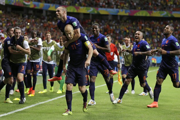 Netherlands' Arjen Robben celebrates with his teammates after scoring his side's fifth goal during the second half of the group B World Cup soccer match between Spain and the Netherlands at the Arena Ponte Nova in Salvador, Brazil, Friday, June 13, 2014.  (AP Photo/Natacha Pisarenko)