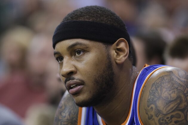 New York Knicks' Carmelo Anthony (7) looks on as he sits on the bench in the second quarter during an NBA basketball game against the Utah Jazz Monday, March 31, 2014, in Salt Lake City. (AP Photo/Rick Bowmer)