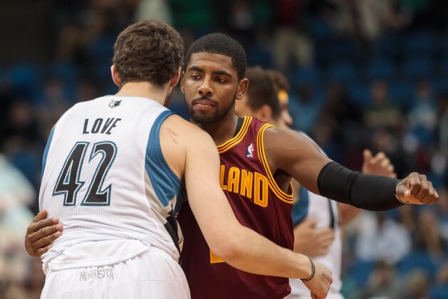 Nov 13, 2013; Minneapolis, MN, USA; Minnesota Timberwolves power forward Kevin Love (42) and Cleveland Cavaliers point guard Kyrie Irving (2) hug before the tip off at Target Center. Mandatory Credit: Brad Rempel-USA TODAY Sports