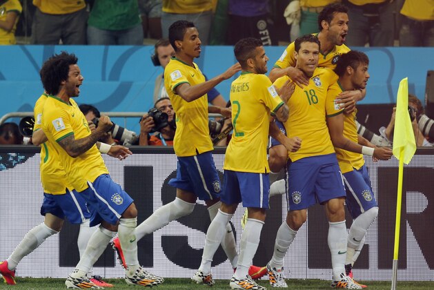 Brazil players celebrate after Neymar, right, scored a penalty kick during the group A World Cup soccer match between Brazil and Croatia, the opening game of the tournament, in the Itaquerao Stadium in Sao Paulo, Brazil, Thursday, June 12, 2014.  (AP Photo/Frank Augstein)