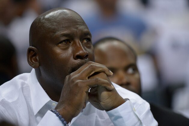 CHARLOTTE, NC - APRIL 26:  Michael Jordan watches as the Charlotte Bobcats play the Miami Heat in Game Three of the Eastern Conference Quarterfinals during the 2014 NBA Playoffs at Time Warner Cable Arena on April 26, 2014 in Charlotte, North Carolina. NOTE TO USER: User expressly acknowledges and agrees that, by downloading and or using this photograph, User is consenting to the terms and conditions of the Getty Images License Agreement.  (Photo by Grant Halverson/Getty Images)