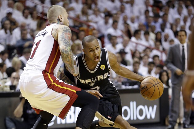San Antonio Spurs guard Patty Mills (8) drives around Miami Heat forward Chris Andersen (11) in the second half in Game 3 of the NBA basketball finals, Tuesday, June 10, 2014, in Miami.  (AP Photo/Wilfredo Lee)