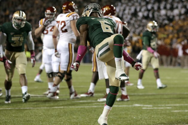 In this Oct. 19, 2013, photo, Baylor safety Ahmad Dixon (6) celebrates a defensive stop against Iowa State deep in Iowa State territory in the second half of an NCAA college football game in Waco, Texas. Dixon takes a deep breath and has the same thought each time he gets to the sideline after a defensive stop. ``I'm just like, Wow, this is really us, this is who we are,'' Dixon said. Baylor won the game 71-7. (AP Photo/Tony Gutierrez, file)