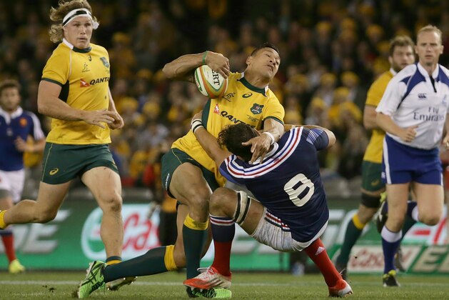 Australia's Israel Folau, center left, is tackled by France's Damien Chouly during their rugby test match in Melbourne, Australia, Saturday, June 14, 2014. (AP Photo/Hamish Blair)