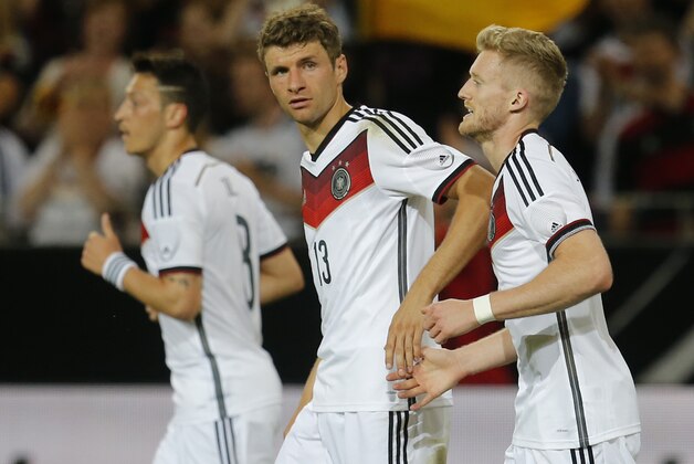 Germany's Andre Schuerrle, right, celebrates his side's opening goal with team mate Thomas Mueller  during a soccer friendly match between Germany and Armenia in the Coface Arena in Mainz, Germany, Friday, June 6, 2014. (AP Photo/Michael Probst)