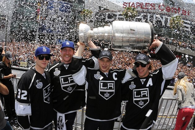 LOS ANGELES, CA - JUNE 14:  Jonathan Quick #32, Matt Greene #2, Dustin Brown #23 and Anze Kopitar #11 hold up the Stanley Cup during the Los Angeles Kings Parade and Rally on June 14, 2012 at Staples Center in Los Angeles, California. (Photo by Juan Ocampo/NHLI via Getty Images)