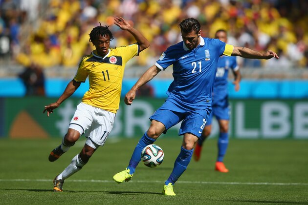 BELO HORIZONTE, BRAZIL - JUNE 14: Konstantinos Katsouranis of Greece controls the ball against Juan Guillermo Cuadrado of Colombia during the 2014 FIFA World Cup Brazil Group C match between Colombia and Greece at Estadio Mineirao on June 14, 2014 in Belo Horizonte, Brazil.  (Photo by Paul Gilham/Getty Images)