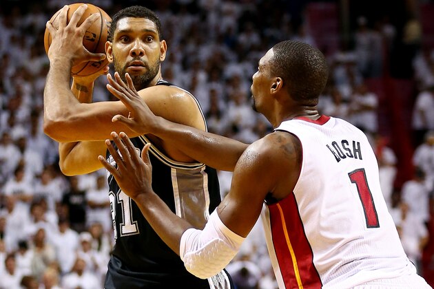 MIAMI, FL - JUNE 12: Tim Duncan #21 of the San Antonio Spurs looks to pass as Chris Bosh #1 of the Miami Heat defends during Game Four of the 2014 NBA Finals at American Airlines Arena on June 12, 2014 in Miami, Florida. NOTE TO USER: User expressly acknowledges and agrees that, by downloading and or using this photograph, User is consenting to the terms and conditions of the Getty Images License Agreement.  (Photo by Andy Lyons/Getty Images)