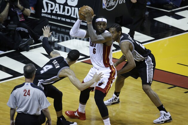 San Antonio Spurs guard Danny Green (4) and forward Kawhi Leonard (2) apply pressure on Miami Heat forward LeBron James (6) in the first half in Game 4 of the NBA basketball finals, Thursday, June 12, 2014, in Miami. (AP Photo/Wilfredo Lee)