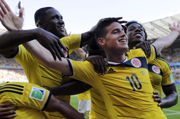 Colombia's James Rodriguez (10) celebrates with his teammates after scoring his side's third goal during the group C World Cup soccer match between Colombia and Greece at the Mineirao Stadium in Belo Horizonte, Brazil, Saturday, June 14, 2014. Colombia defeated Greece 3-0. (AP Photo/Fernando Vergara)