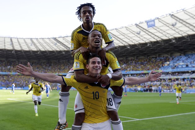 Colombia's James Rodriguez (10) celebrates with his teammates after scoring his side's third goal during the group C World Cup soccer match between Colombia and Greece at the Mineirao Stadium in Belo Horizonte, Brazil, Saturday, June 14, 2014. Colombia defeated Greece 3-0. (AP Photo/Fernando Vergara)