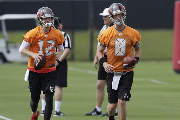 Tampa Bay Buccaneers quarterbacks Josh McCown (12) and Mike Glennon run during a organized team activity Tuesday, May 27, 2014, in Tampa, Fla. (AP Photo/Chris O'Meara)