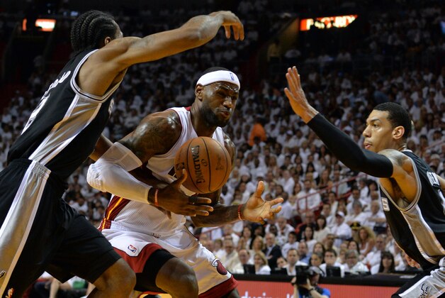 Jun 10, 2014; Miami, FL, USA; Miami Heat forward LeBron James (6) drives against San Antonio Spurs guard Danny Green (right) and forward Kawhi Leonard (left) during the first half of game three of the 2014 NBA Finals at American Airlines Arena. Mandatory Credit: Steve Mitchell-USA TODAY Sports