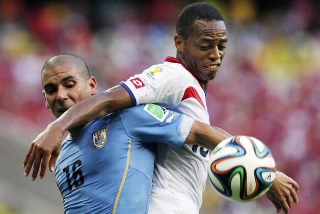Uruguay's Maxi Pereira (16) struggles with Costa Rica's Junior Diaz during the group D World Cup soccer match between Uruguay and Costa Rica at the Arena Castelao in Fortaleza, Brazil, Saturday, June 14, 2014.  (AP Photo/Fernando Llano)