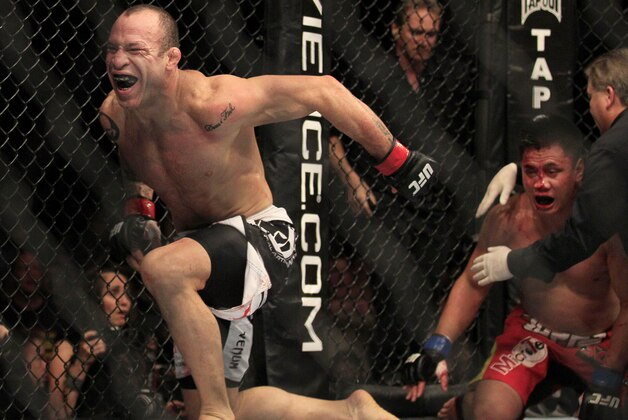 Wanderlei Silva, left, celebrates after beating Cung Le, right, during the second round of a UFC 139 Mixed Martial Arts middleweight bout in San Jose, Calif., Saturday, Nov. 19, 2011. Silva won by TKO in the second round. (AP Photo/Jeff Chiu)