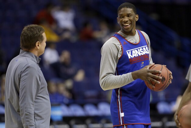 Kansas' Joel Embiid, right, talks with head coach Bill Self during practice for the NCAA college basketball tournament Thursday, March 20, 2014, in St. Louis. Kansas is scheduled to play Eastern Kentucky in a second-round game on Friday. (AP Photo/Jeff Roberson)