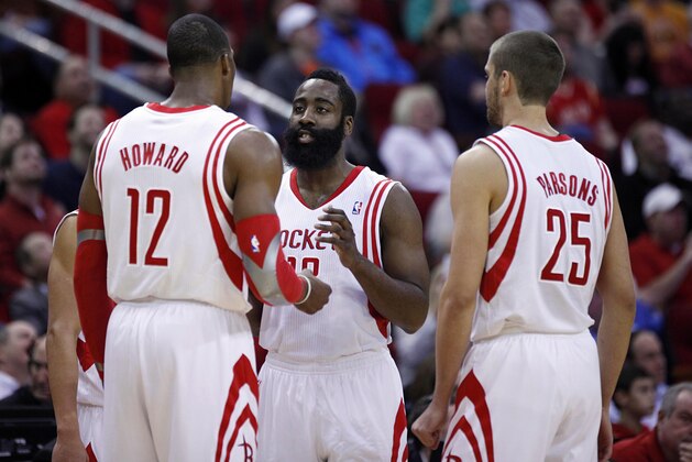 Jan 16, 2014; Houston, TX, USA; Houston Rockets shooting guard James Harden (13) speaks with power forward Dwight Howard (12) and small forward Chandler Parsons (25) during the first quarter against the Oklahoma City Thunder at Toyota Center. Mandatory Credit: Andrew Richardson-USA TODAY Sports