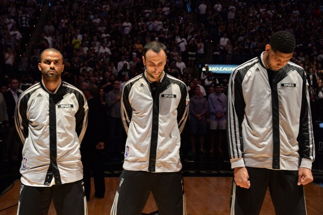 SAN ANTONIO, TX - JUNE 08: Tony Parker #9, Manu Ginobili #20 and Tim Duncan #21 of the San Antonio Spurs stand in observance of the national anthem before Game Two of the 2014 NBA Finals between the Miami Heat and San Antonio Spurs at AT&T Center on June 8, 2014 in San Antonio, Texas. NOTE TO USER: User expressly acknowledges and agrees that, by downloading and/or using this photograph, user is consenting to the terms and conditions of the Getty Images License Agreement.  Mandatory Copyright Notice: Copyright 2014 NBAE (Photo by Andrew D Bernstein/NBAE via Getty Images)