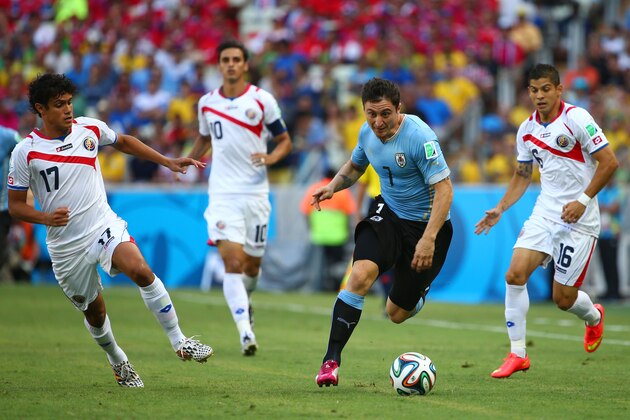 FORTALEZA, BRAZIL - JUNE 14:  Cristian Rodriguez of Uruguay controls the ball against Yeltsin Tejeda of Costa Rica during the 2014 FIFA World Cup Brazil Group D match between Uruguay and Costa Rica at Castelao on June 14, 2014 in Fortaleza, Brazil.  (Photo by Robert Cianflone/Getty Images)