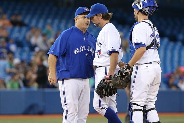 TORONTO, CANADA - JUNE 9: R.A. Dickey #43 of the Toronto Blue Jays is relieved by manager John Gibbons #5 in the sixth inning during MLB game action against the Minnesota Twins on June 9, 2014 at Rogers Centre in Toronto, Ontario, Canada. (Photo by Tom Szczerbowski/Getty Images)