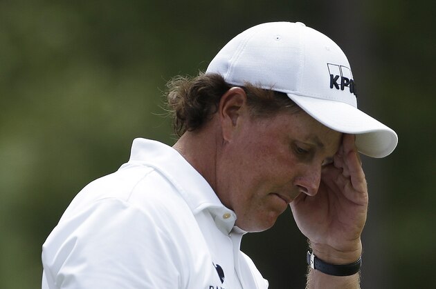 Phil Mickelson reacts to his tee shot on the ninth hole during the third round of the U.S. Open golf tournament in Pinehurst, N.C., Saturday, June 14, 2014. (AP Photo/David Goldman)