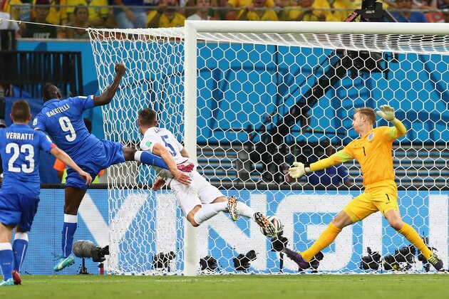 MANAUS, BRAZIL - JUNE 14:  Mario Balotelli of Italy scores his team's second goal on a header past Gary Cahill (C) and goalkeeper Joe Hart of England during the 2014 FIFA World Cup Brazil Group D match between England and Italy at Arena Amazonia on June 14, 2014 in Manaus, Brazil.  (Photo by Elsa/Getty Images)