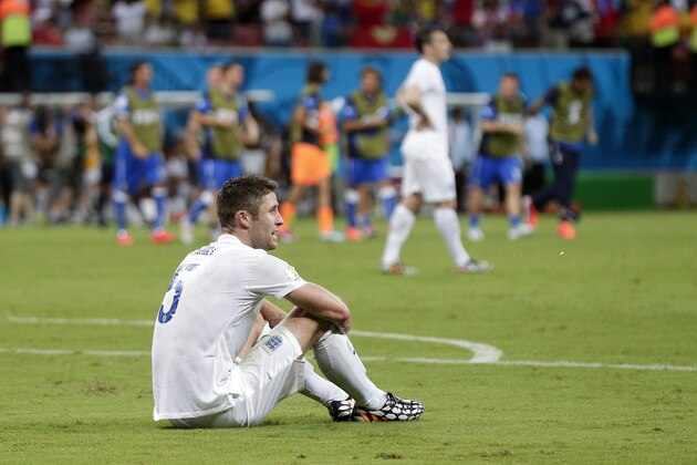 England's Gary Cahill sits on the pitch following England's 2-1 loss to Italy in their group D World Cup soccer match at the Arena da Amazonia in Manaus, Brazil, Saturday, June 14, 2014.  (AP Photo/Marcio Jose Sanchez)