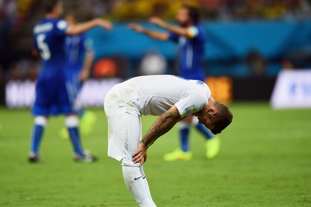 MANAUS, BRAZIL - JUNE 14: A dejected Jack Wilshere of England looks down as Italy celebrate defeating England 2-1 during the 2014 FIFA World Cup Brazil Group D match between England and Italy at Arena Amazonia on June 14, 2014 in Manaus, Brazil.  (Photo by Christopher Lee/Getty Images)
