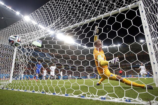 England's goalkeeper Joe Hart fails to stop a goal by Italy's Mario Balotelli's during the second half of the group D World Cup soccer match between England and Italy at the Arena da Amazonia in Manaus, Brazil, Saturday, June 14, 2014. The goal gave Italy a 2-1 win. (AP Photo/Marcio Jose Sanchez)