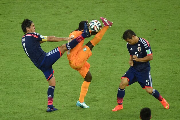 RECIFE, BRAZIL - JUNE 14:  Didier Ya Konan of the Ivory Coast competes for the ball with Yasuhito Endo (L) and Yuto Nagatomo of Japan during the 2014 FIFA World Cup Brazil Group C match  between the Ivory Coast and Japan at Arena Pernambuco on June 14, 2014 in Recife, Brazil.  (Photo by Matthias Hangst/Getty Images)