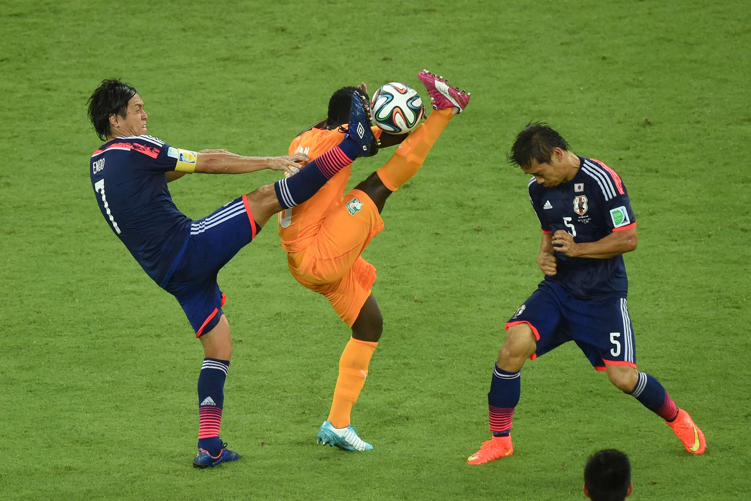 RECIFE, BRAZIL - JUNE 14:  Didier Ya Konan of the Ivory Coast competes for the ball with Yasuhito Endo (L) and Yuto Nagatomo of Japan during the 2014 FIFA World Cup Brazil Group C match  between the Ivory Coast and Japan at Arena Pernambuco on June 14, 2014 in Recife, Brazil.  (Photo by Matthias Hangst/Getty Images)