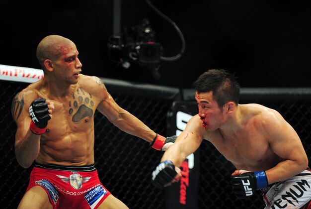 Jun 14, 2014; Vancouver, British Columbia, Canada; Kajan Johnson (red) fights Tae Hyun Bang (blue) during the second round of their Lightweight bout during UFC 174 at Rogers Arena. Mandatory Credit: Anne-Marie Sorvin-USA TODAY Sports