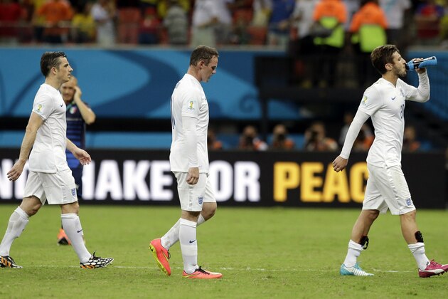 England's Leighton Baines, left, Wayne Rooney and Adam Lallana leave the pitch after the group D World Cup soccer match between England and Italy at the Arena da Amazonia in Manaus, Brazil, Saturday, June 14, 2014. Italy won the match 2-1.   (AP Photo/Matt Dunham)
