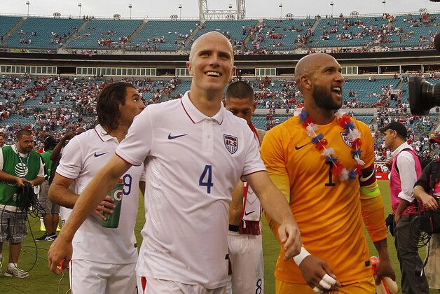 Jun 7, 2014; Jacksonville, FL, USA; United States midfielder Michael Bradley (4) and goalkeeper Tim Howard (1) smile after they beat the Nigeria during the second half at EverBank Field. United States defeated Nigeria 2-1. Mandatory Credit: Kim Klement-USA TODAY Sports