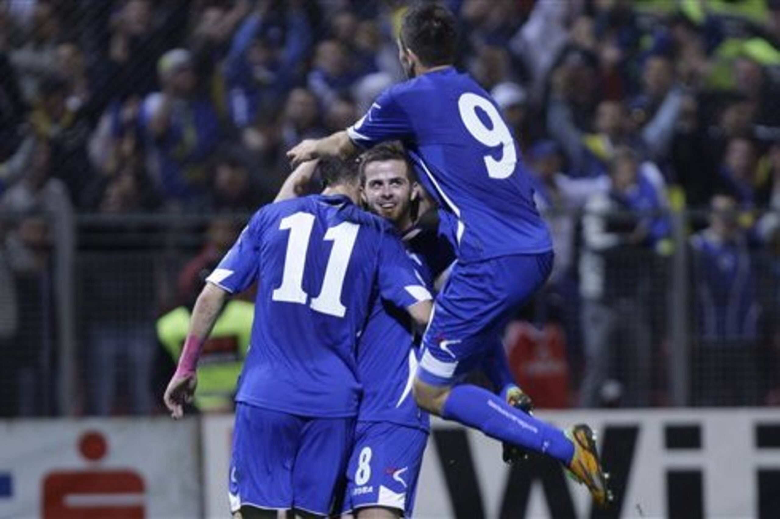 Bosnia's player Pjanic Miralem, center, celebrates his goal against Lithuania, during their World Cup 2014 Group G qualifying soccer match at Stadium Bilino Polje  in Zenica, Bosnia, on Tuesday, Oct. 16, 2012. (AP Photo/Amel Emric)