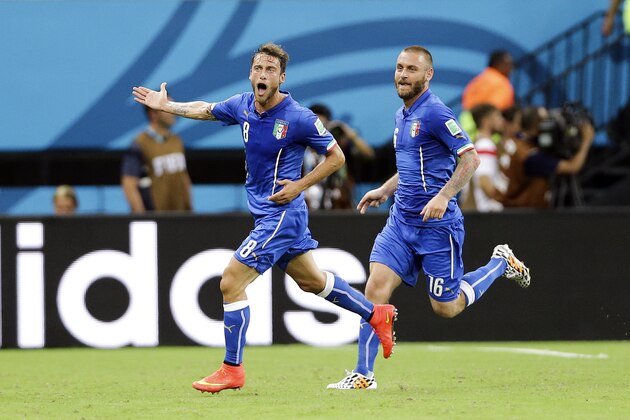Italy's Claudio Marchisio, left, celebrates with Daniele De Rossi, right, after Marchisio scored Italy's first goal during the group D World Cup soccer match between England and Italy at the Arena da Amazonia in Manaus, Brazil, Saturday, June 14, 2014. (Antonio Calanni)