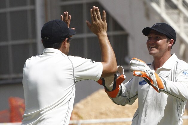 New Zealand's  wicket keeper BJ Watling, right, celebrates with teammate Ross Taylor after taking the wicket of West Indies batsman Chris Gayle, who was caught behind for a 10 runs during the second innings on the fourth day of their first cricket Test match in Kingston, Jamaica, Wednesday, June 11, 2014. (AP Photo/Arnulfo Franco)