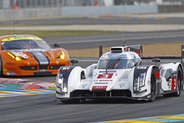 The Audi R18 E-tron driven by Filipe Albuquerque, Marco Bonanomi of Italy, and Oliver Jarvis of Great Britain, in a curve of the Mans circuit, during a free practice session for the 24-hour Le Mans endurance race, in Le Mans, western France, Wednesday, June 11, 2014. The race will take place on Saturday and Sunday. (AP Photo/Remy de la Mauviniere)