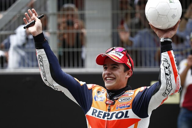MotoGP raider Marc Marquez of Spain celebrates after wining the Catalunya Motorcycle Grand Prix at the Barcelona Catalunya racetrack in Montmelo, near Barcelona, Spain, on Sunday, June 15, 2014. (AP Photo/Andres Kudacki)